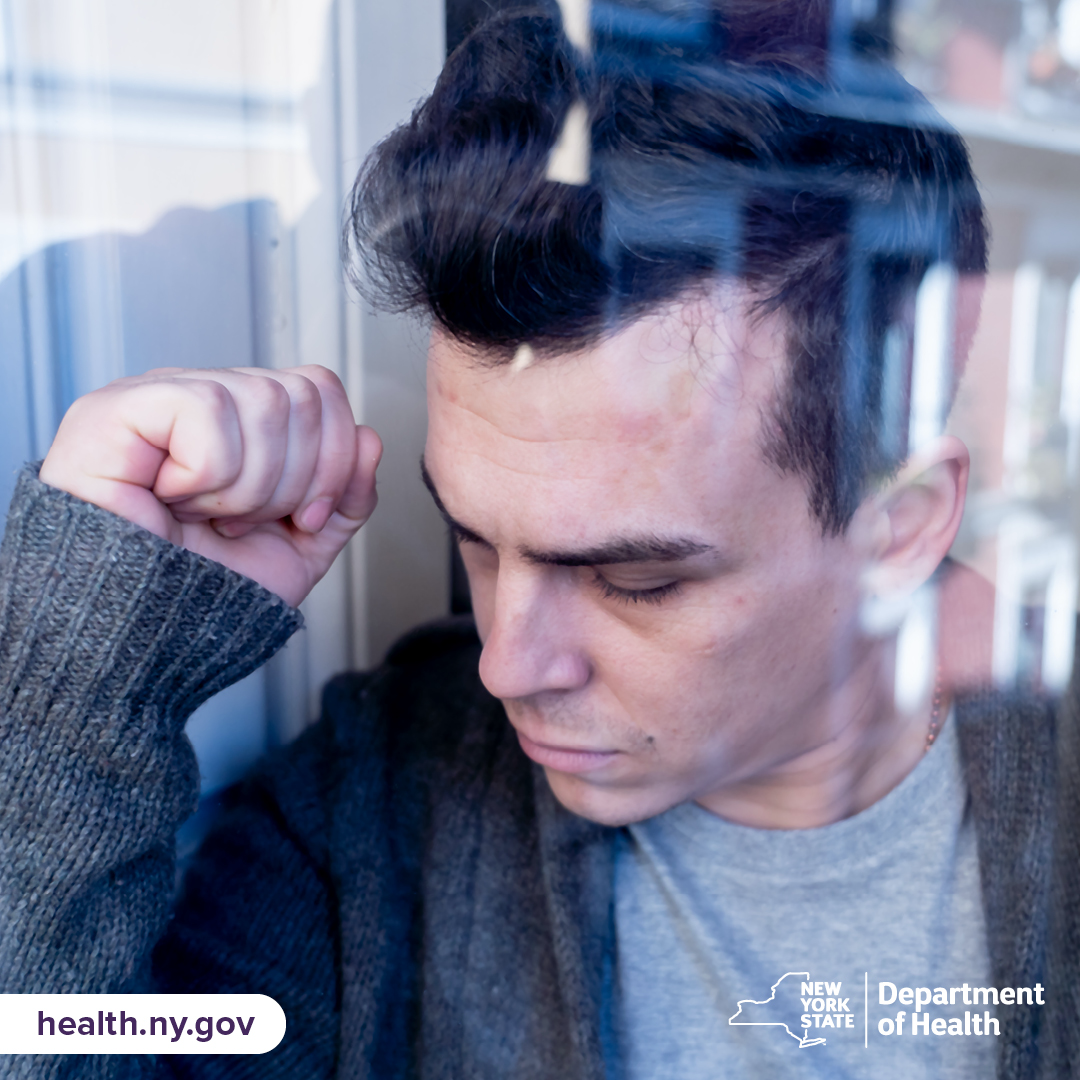 Man pensively facing downward.