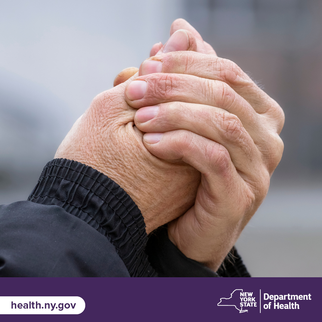 Hands folded to stay warm in the cold.